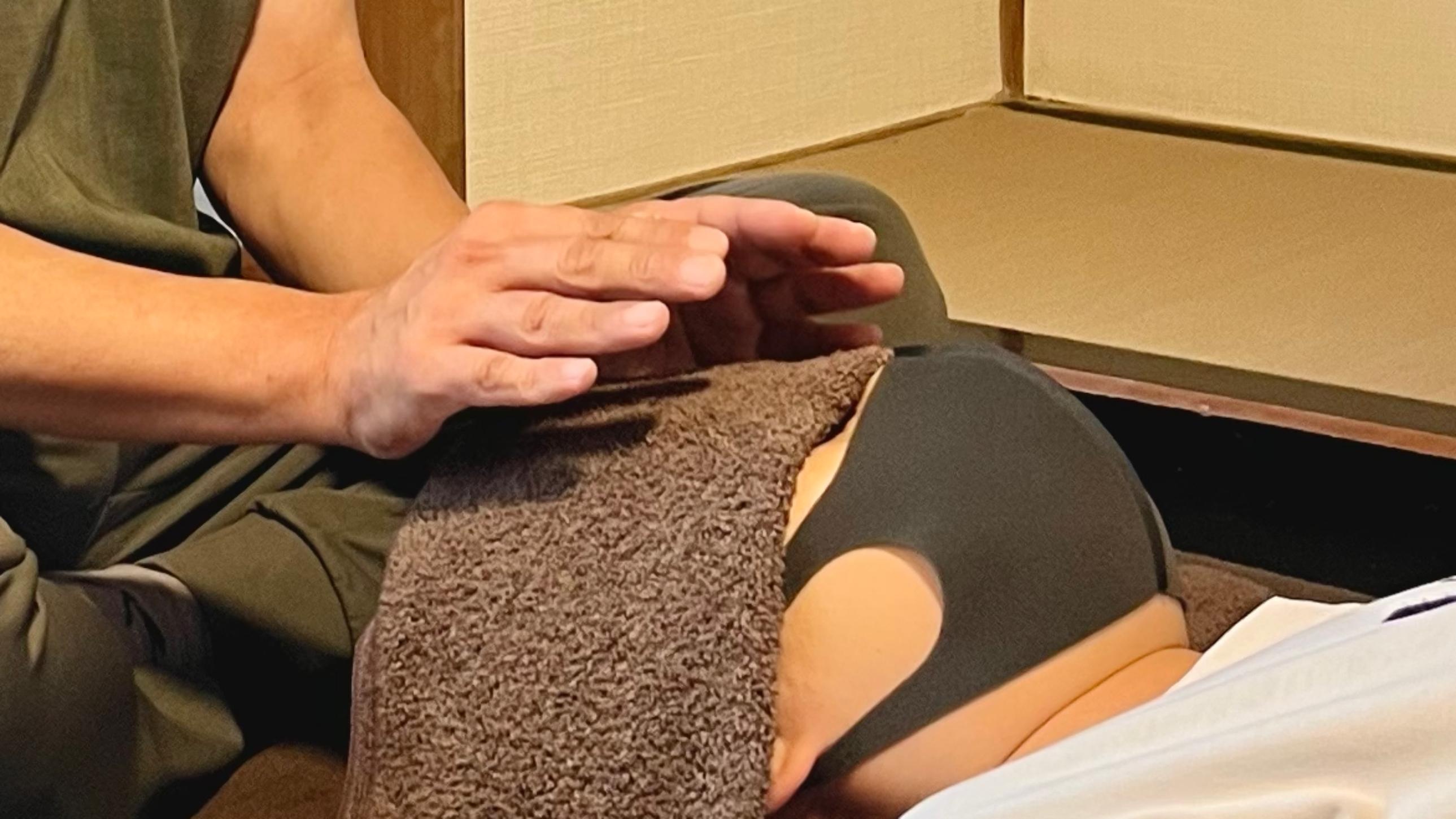 Close-up of hands during Usui Reiki energy healing session in Japan